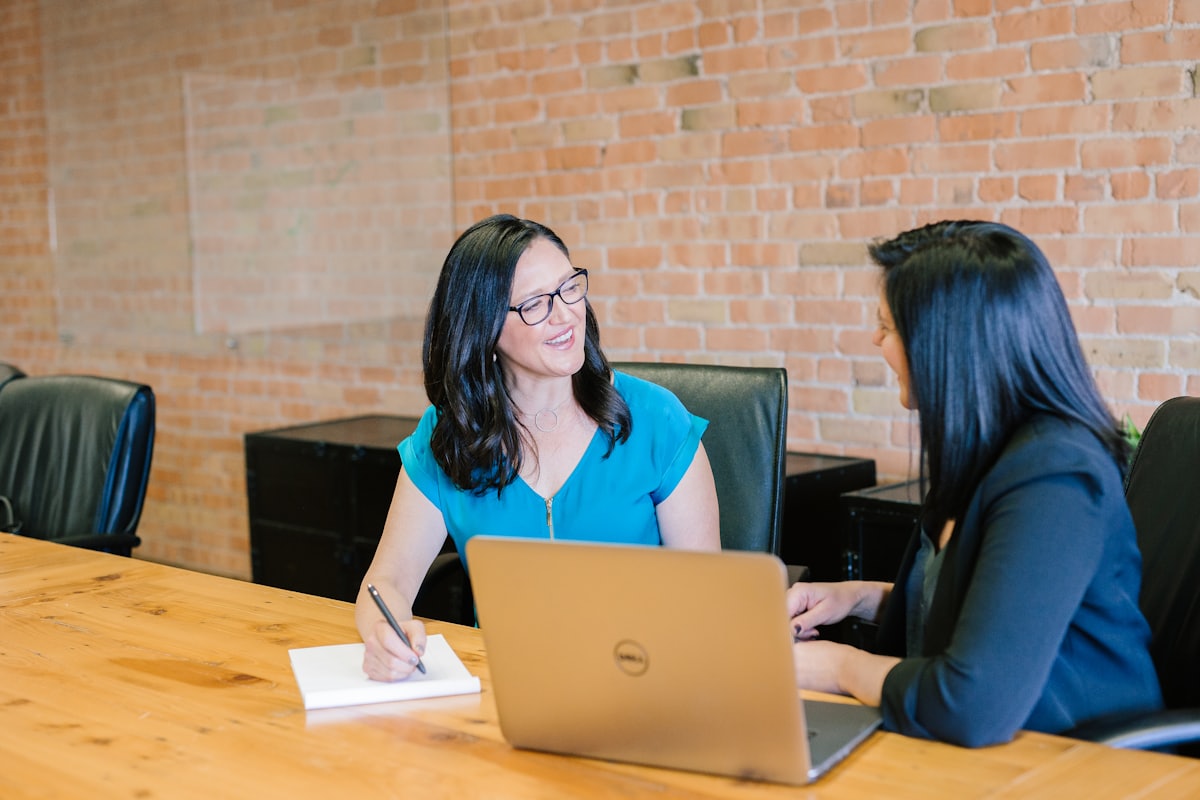 A person being guided through document paperwork at a table
