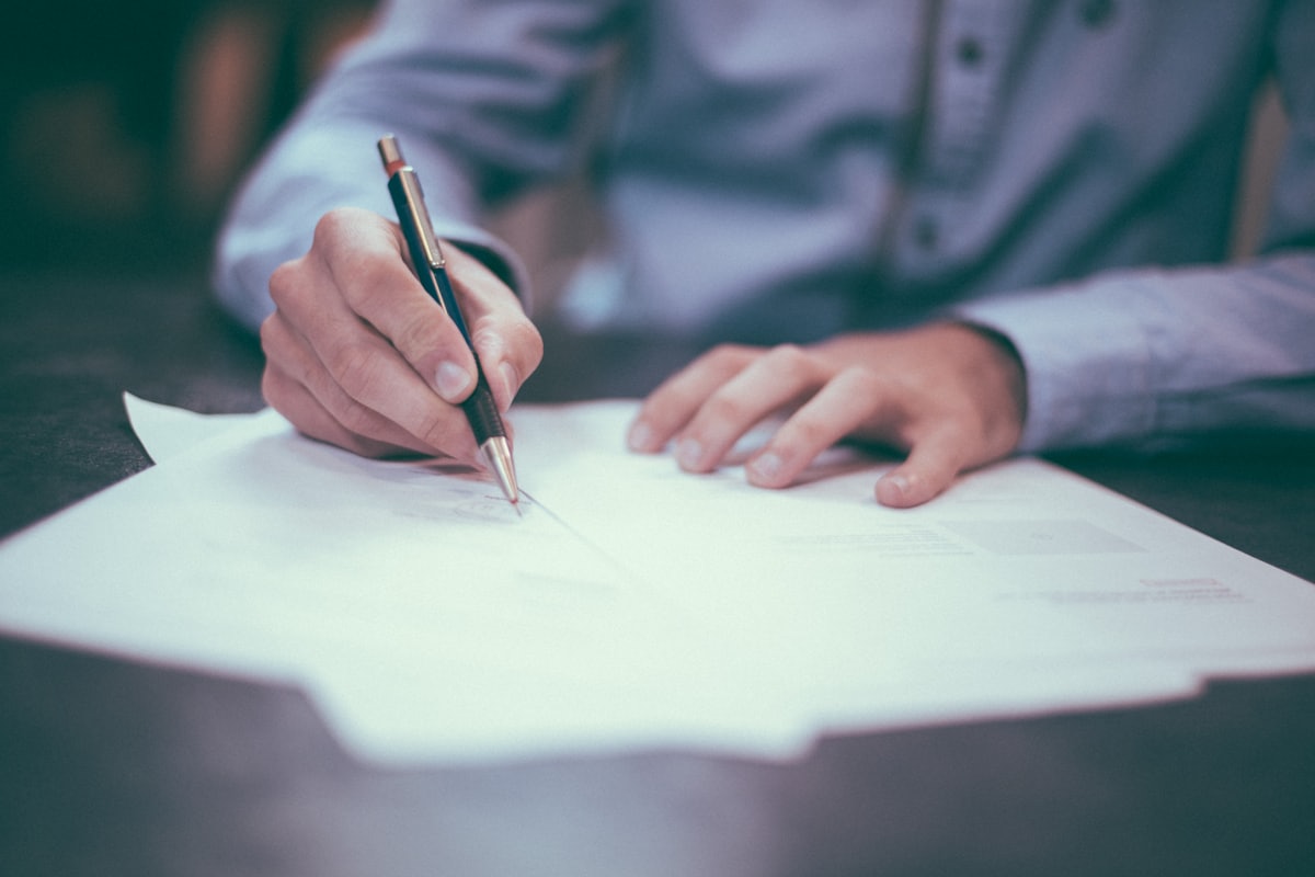 A signer completing a document at a table during a Pacific, Missouri notary visit