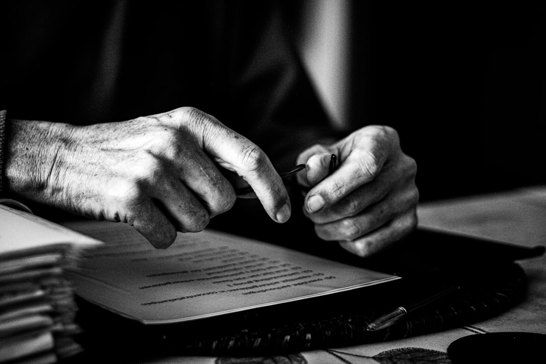 Hands signing a document during a mobile notary appointment